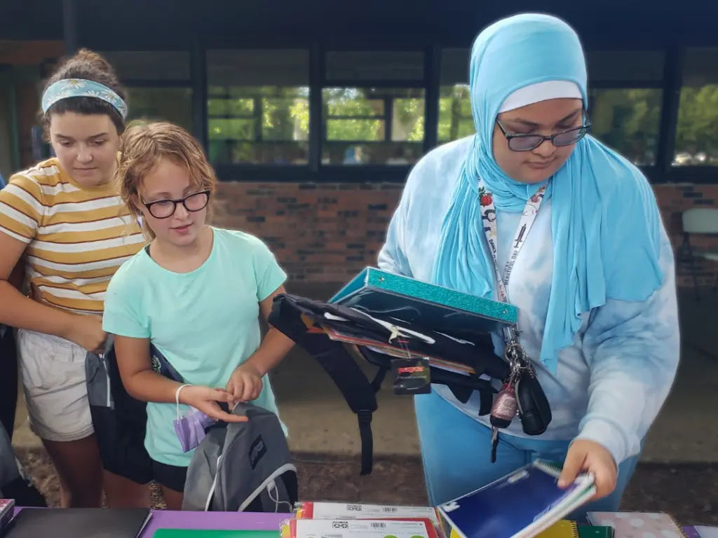 Students picking up school supplies