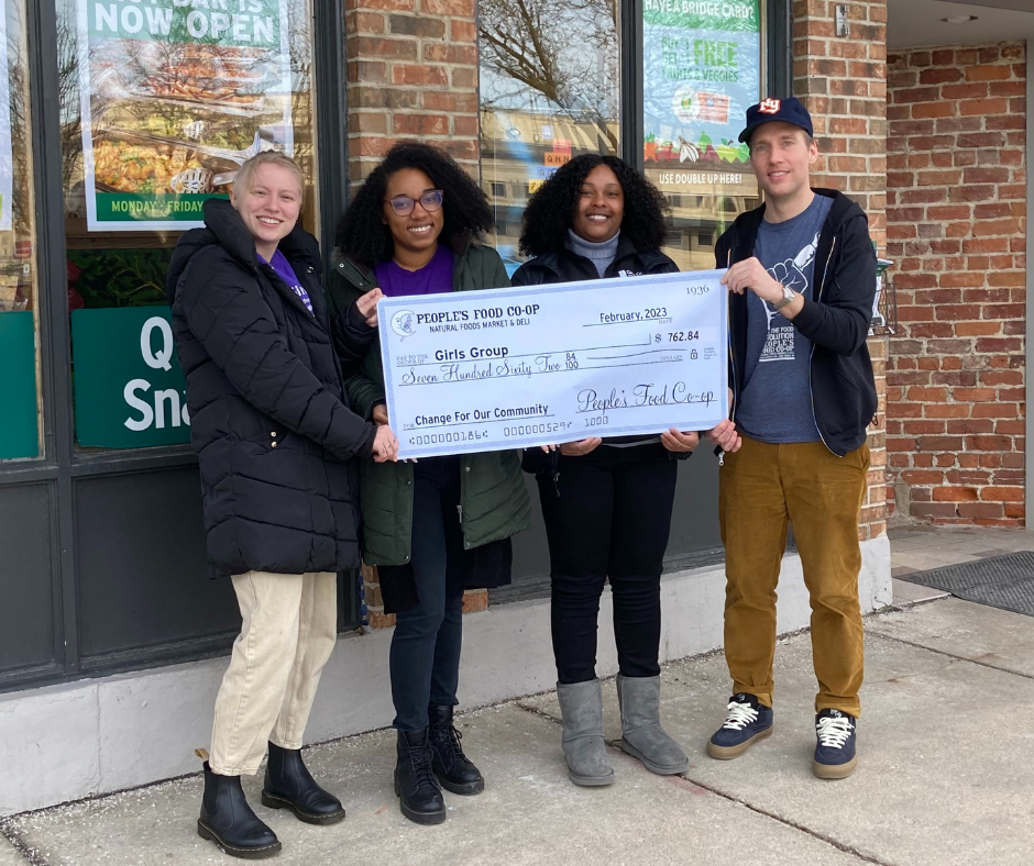 Staff holding check from community funder