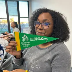 hbcu pathway Participant holding Washtenaw Community College HBCU Pathway banner