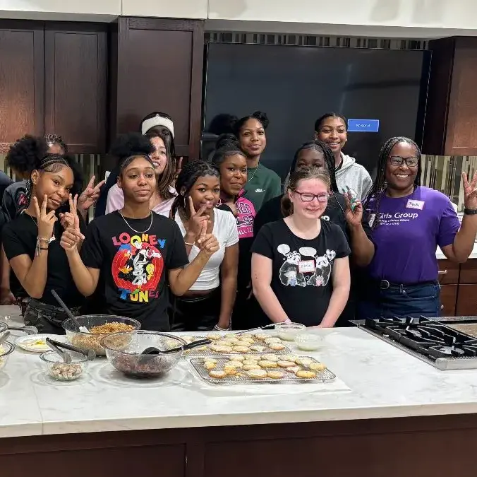 Group of participants in a kitchen with ingredients